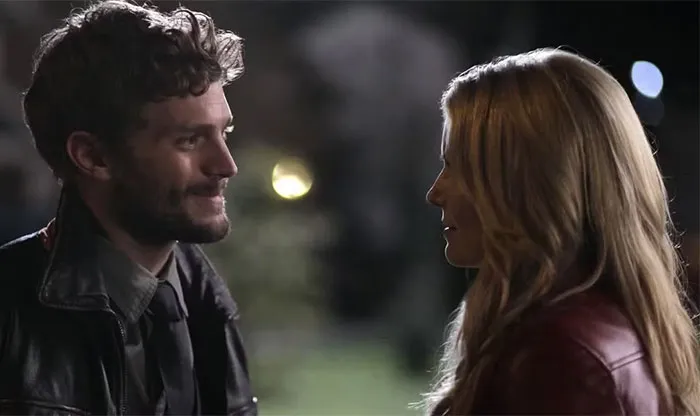 Two TV characters looking at each other outside at night, representing TV couples with little chemistry.
