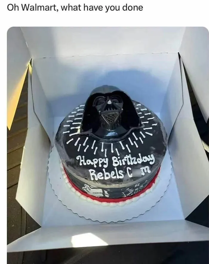 Darth Vader cake with "Happy Birthday Rebels Cum" misspelled, inside a box, creating an amusingly awkward moment.