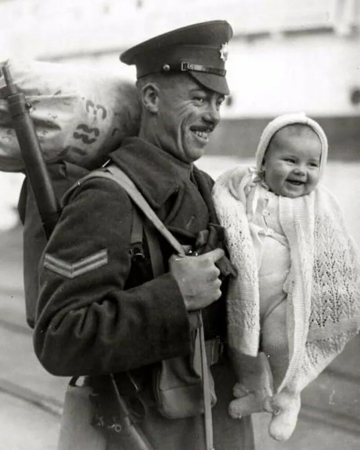 A British Soldier With His 8-Month Old Daughter As He Arrives At The Docks From Overseas, 1945