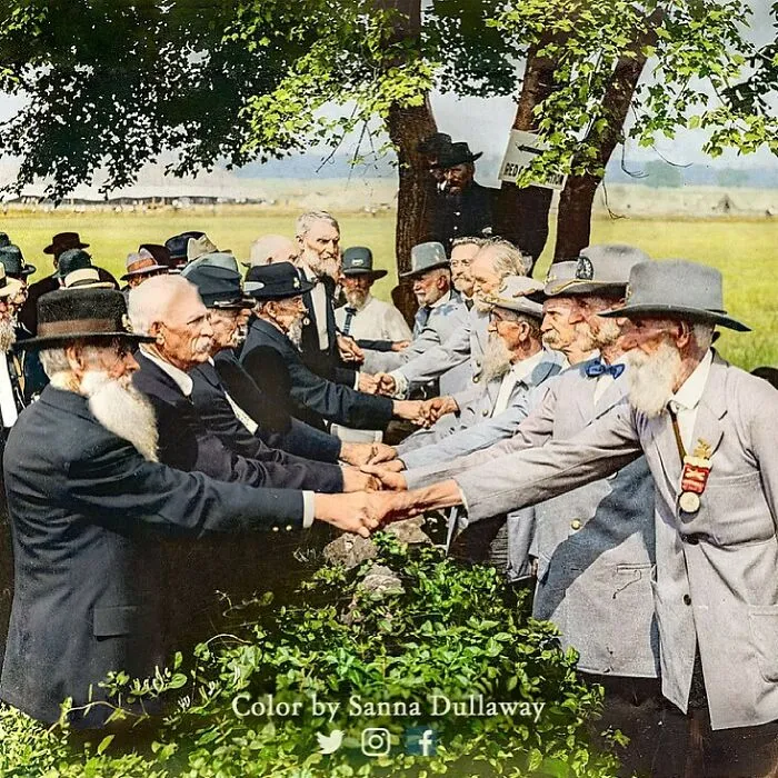 Union Blue And Confederate Gray Veterans Reunite At Gettysburg In The Year 1913 — Standing By “The Bloody Angle” Where Pickett’s Charge Took Place 50 Years Earlier And Over 3,000 Soldiers On Both Sides Lost Their Lives — Now They Clasp Hands Over The Stone Wall As Brothers