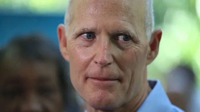 A man in a blue shirt with a pensive expression, relevant to Florida Man headlines.