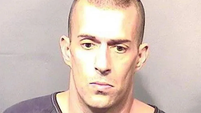 Man in a black shirt, associated with Florida Man headlines, facing forward in a neutral expression.