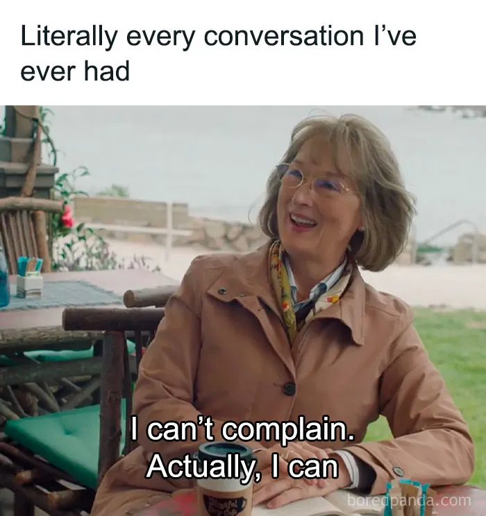 Woman in a tan coat sitting at a table, smiling with text overlay: "I can't complain. Actually, I can." Women's humor meme.