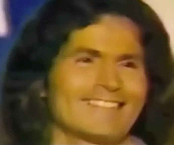 Portrait of a smiling person with long dark hair. The eerie context adds to the photo's creepy aura.