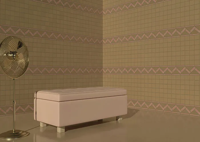 A pink bench and fan in a patterned room with geometric wallpaper design.