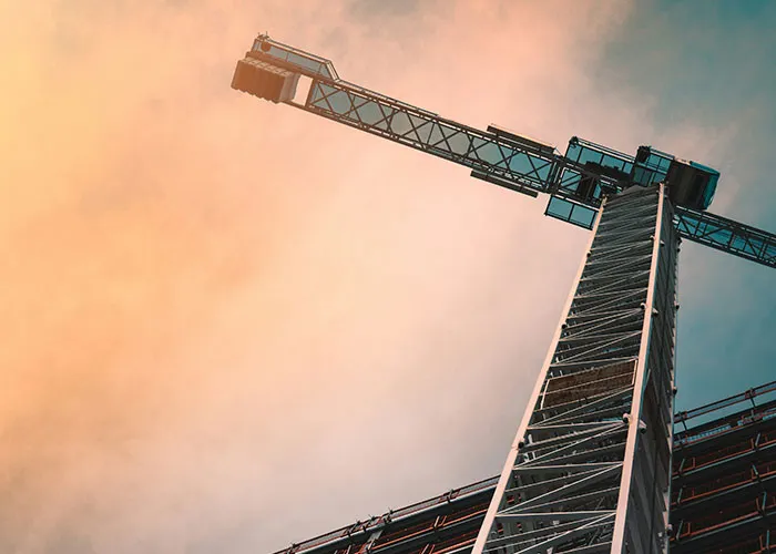 Construction crane against a dramatic sky, symbolizing intense "I need to leave now" experiences.