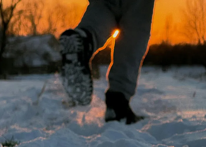Person running on snow at sunset, depicting a hasty escape experience.