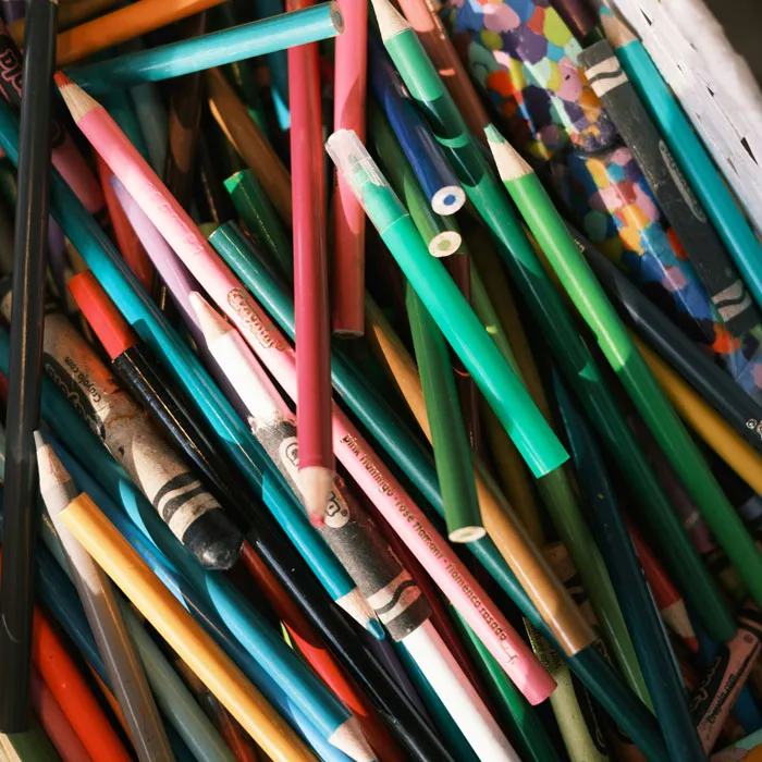 A colorful assortment of pencils and crayons scattered in a box, symbolizing creative job hunting strategies.