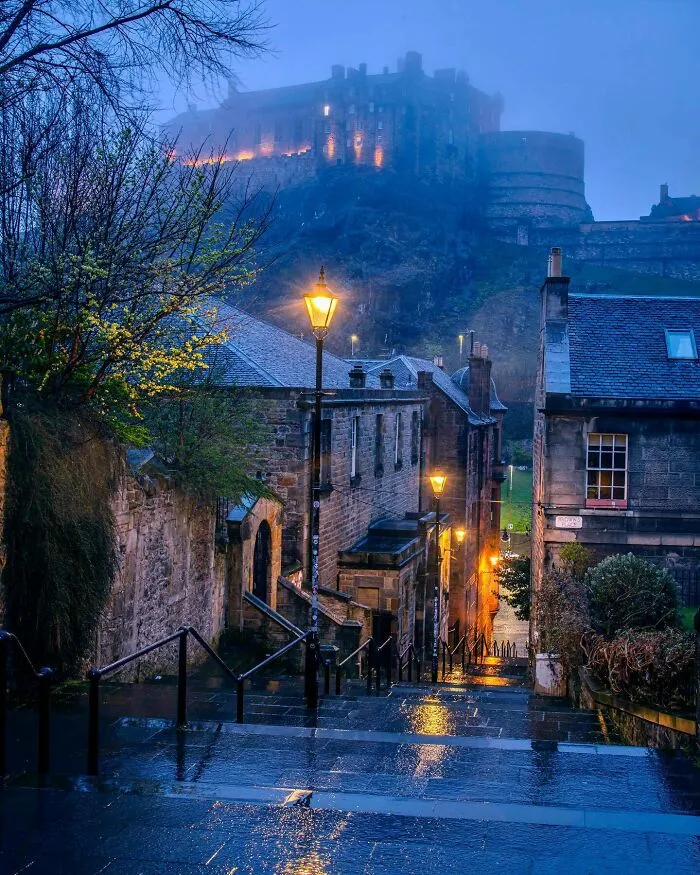 Edinburgh Castle At A Distance Seen From The Rain Drenched Vennel Steps Lit With Street Lamps, Edinburgh, Scotland