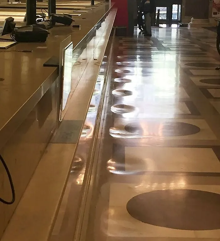 The Marble Floor Of This Bank Has Been Worn Down From Years Of People Standing