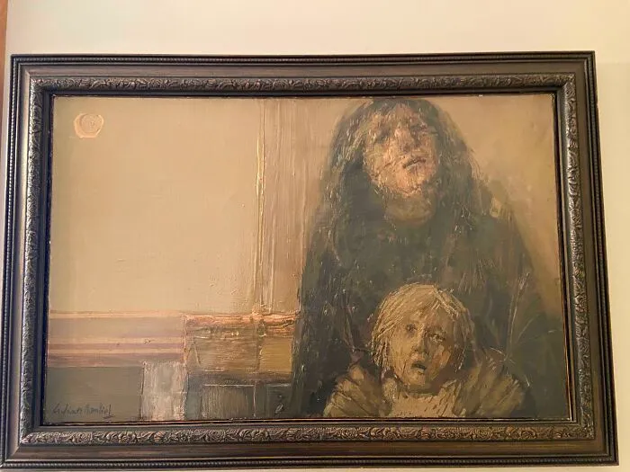 Cuadro oscuro en pared mostrando figuras humanas con expresión asustada, relacionado con personas asustadas tras mudanza.