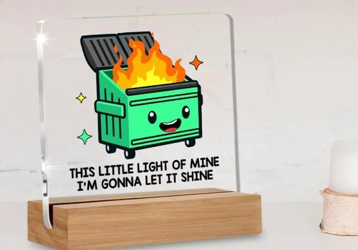 Cute dumpster fire desk accessory with motivational phrase, perfect for brightening up work supplies.