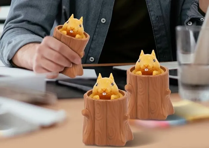 Cute work supplies featuring playful animal figures in wooden cups on a desk for a fun Monday mood.