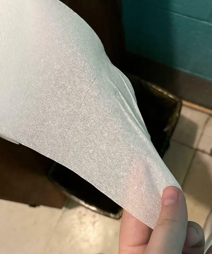 Transparent toilet paper held by a hand, depicting a humorous situation related to infuriating bosses.