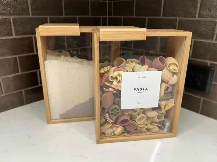 Everyone’s Still Living That Pasta-In-The-Bag Life While Your <a Style="Display:inline;" Href="Https://Www.amazon.com/Apt-1101-Dispenser-Cereal-Organization/Dp/B0djgq8kj9?ie=utf8&th=1&linkcode=ll1&tag=bpmoose-20&linkid=74ca04f8a0a58ee2641f0786612ae366&language=en_us&ref_=as_li_ss_tl" Target="_blank"><span Style="Font: Inherit; Color: #d74b1f;"> Sleek Bamboo And Acrylic Food Storage Containers </Span> Are Serving Countertop Elegance With A Side Of "I Obviously Have My Life Together"