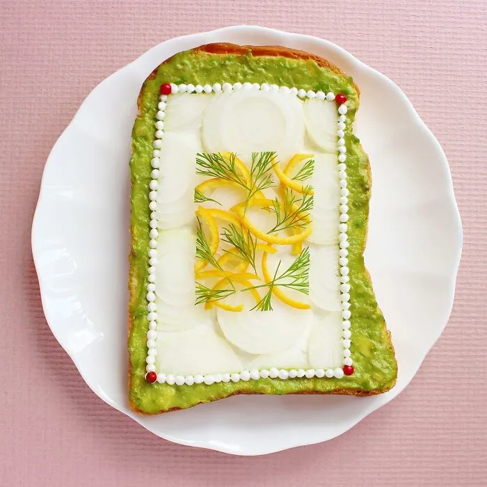 Creative toast design with sliced vegetables and dill on white plate by Japanese artist.
