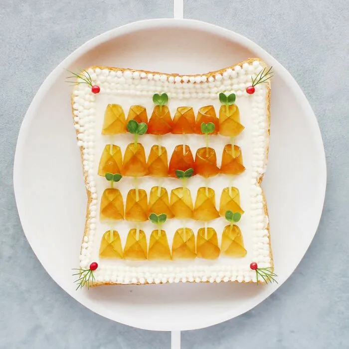 Creative toast design featuring geometric patterns with fruit and garnish accents on a white plate.