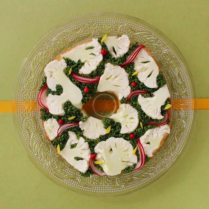 Creative toast design with cauliflower, greens, and radish, crafted by Japanese artist, displayed on a decorative plate.