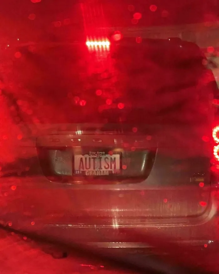 Blurred photo of a vehicle with a license plate reading autism, one of the unremarkable photos entertaining viewers.