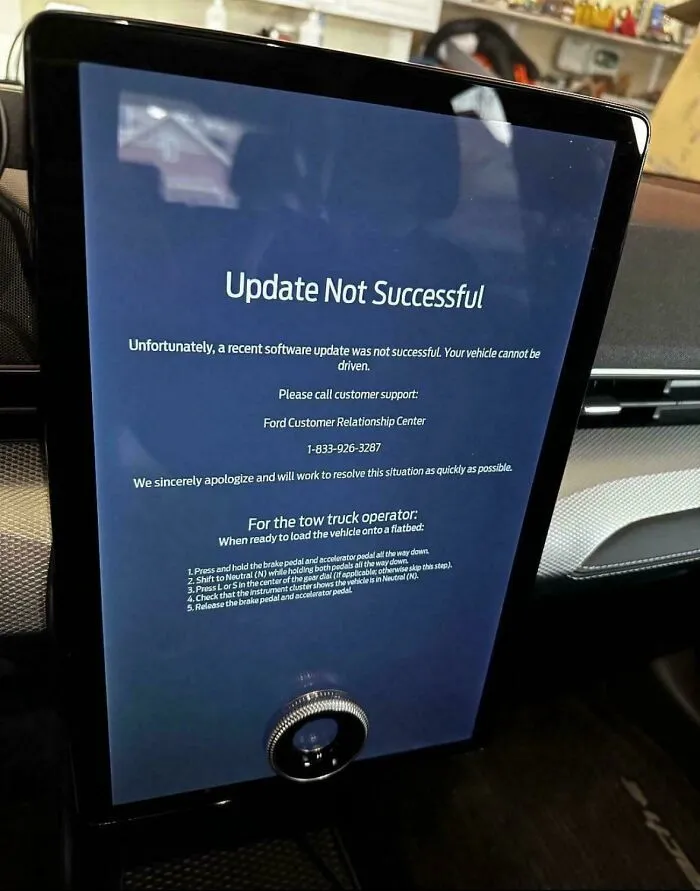 Car dashboard screen showing an update not successful message, reflecting current life in the US through Americans' eyes.