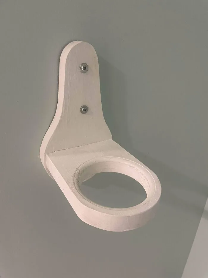 White wooden wall mount with circular cutout, one of the mystery objects recognized by an online group.