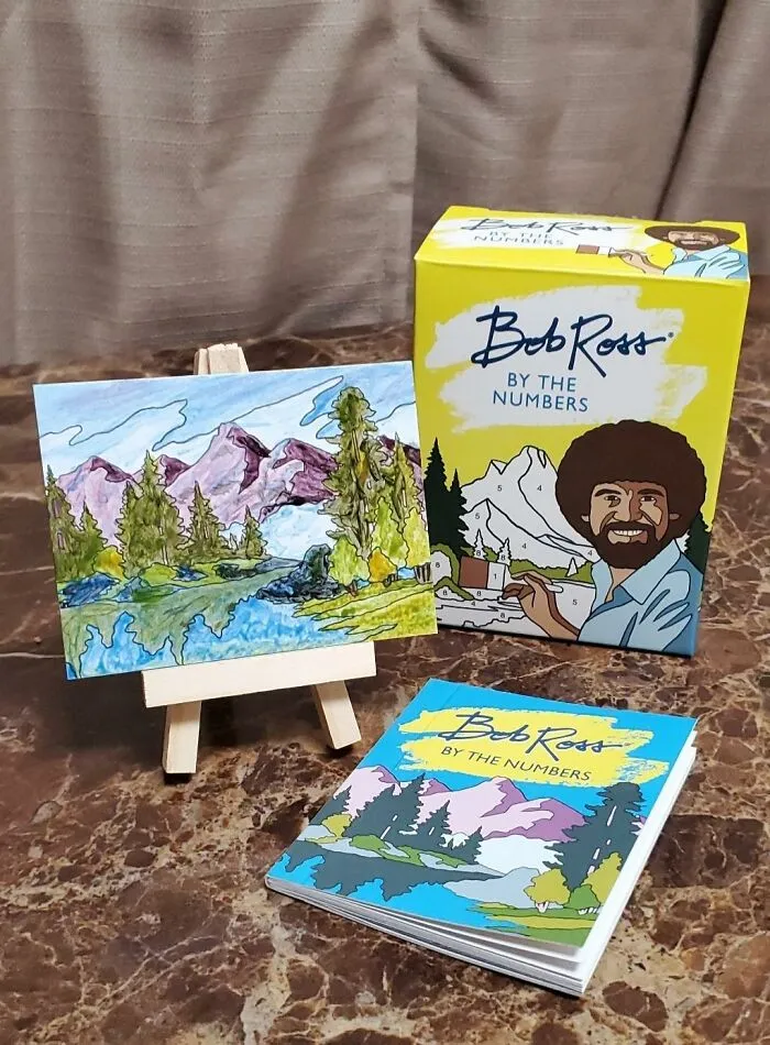 Unleash Your Inner Artist And Experience The Simple Joy Of Creating "Happy Little Trees" With This <a Style="Display:inline;" Href="Https://Www.amazon.com/Bob-Ross-Numbers-Miniature-Editions/Dp/076249168x?ie=utf8&linkcode=ll1&tag=bpapple-20&linkid=cabc1224733f8203af28bcabfa5d5cbd&language=en_us&ref_=as_li_ss_tl" Target="_blank"><span Style="Font:inherit;color:#d74b1f;"> Mini Bob Ross By The Numbers</Span> Kit - Guaranteed To Channel Good Vibes And Maybe Produce A Masterpiece