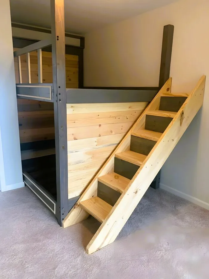 Woodworking ideas bunk bed with natural wood stairs and gray accents in a minimalist bedroom setting.