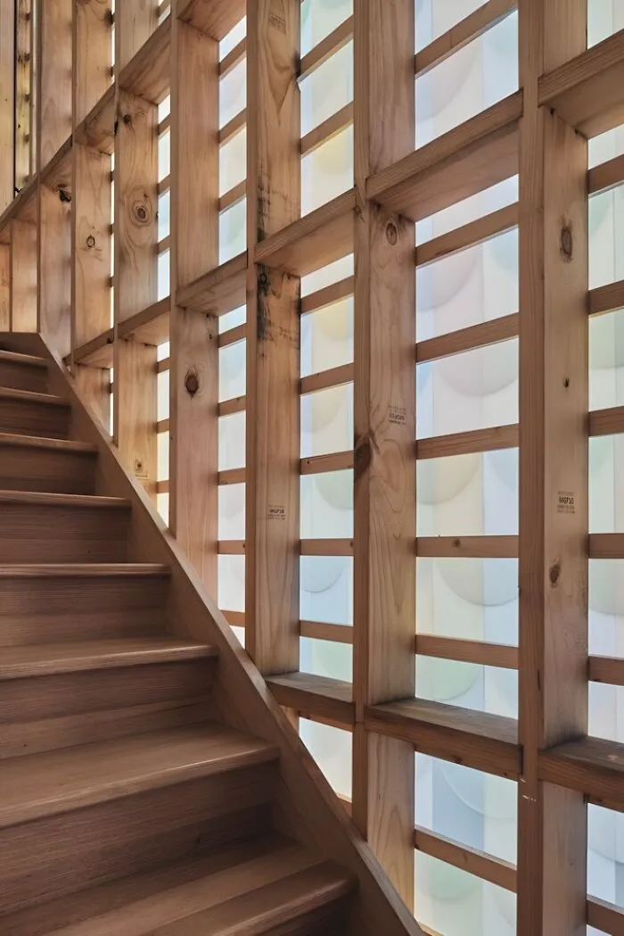 Wooden staircase with a modern grid-style railing showcasing creative woodworking ideas and craftsmanship details.