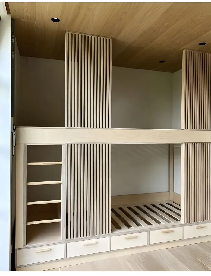 Modern wooden bunk bed with built-in ladder and storage drawers showcasing creative woodworking ideas.