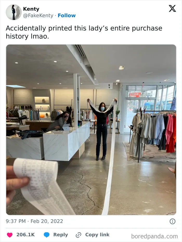 Person holding an excessively long receipt inside a clothing store, showcasing people having a worse day.