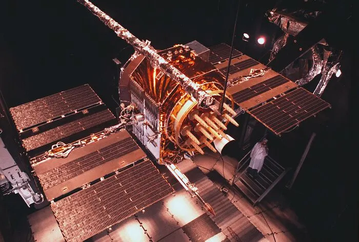 Satellite in assembly, highlighting future-predicted space exploration advancements in a historical context.