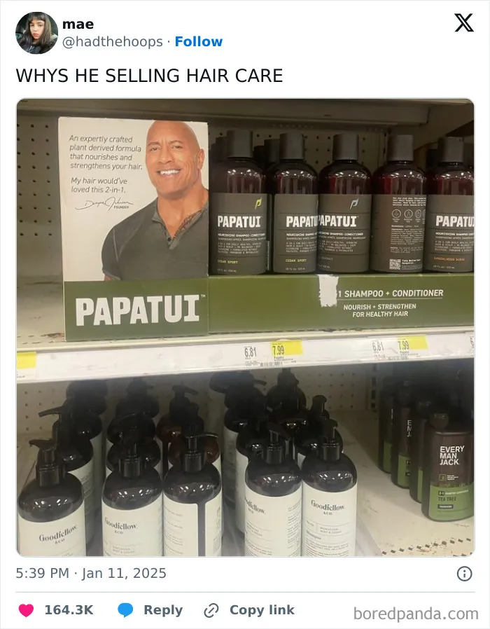 Shampoo display with a standee of a smiling man advertising hair care products in a humorous retail setup.