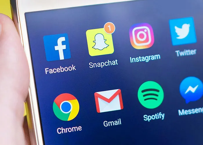 Smartphone screen showing social media apps including Snapchat with notification, related to heartbroken people catching cheating.