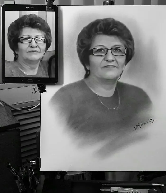 Hyper-realistic pencil portrait of a woman, showing a side-by-side of the drawing and the reference photo on a tablet.