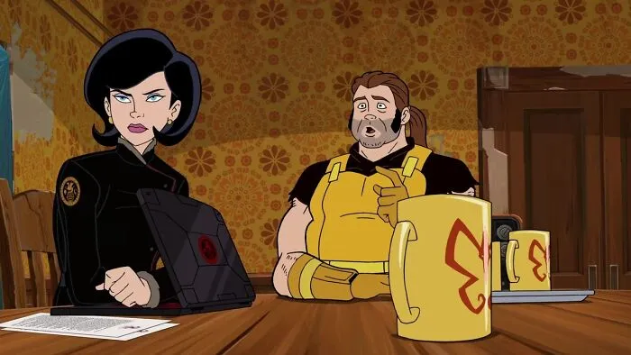 Animated characters at a table with mugs, in a scene from a 10/10 show.