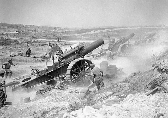 Soldiers operating large artillery cannons in a smoky battlefield, illustrating important moments in history.