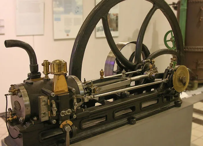 Antique industrial steam engine machinery displayed in a museum representing important moments in history.