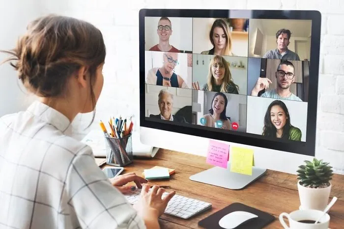 Person participating in a virtual job interview, exploring red flags on a video call with multiple participants.
