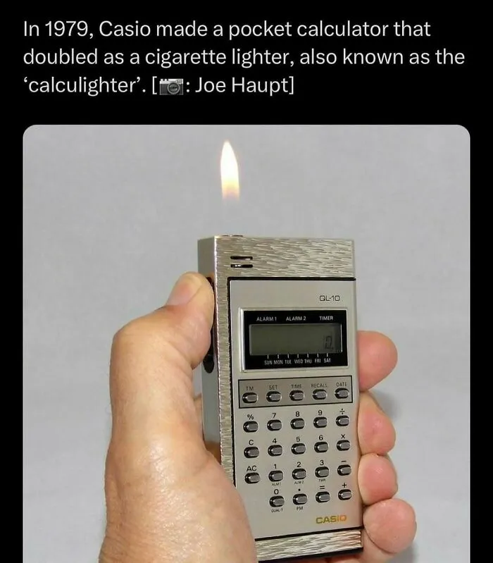 Hand holding a vintage 1979 Casio pocket calculator that doubles as a cigarette lighter, shown with a flame lit.