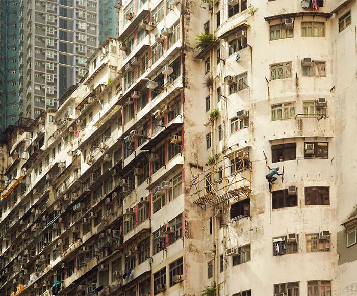 Holding On To The Rope, 2024 - A Worker Is Holding On To A Rope While Working On Facade Of An Old Building