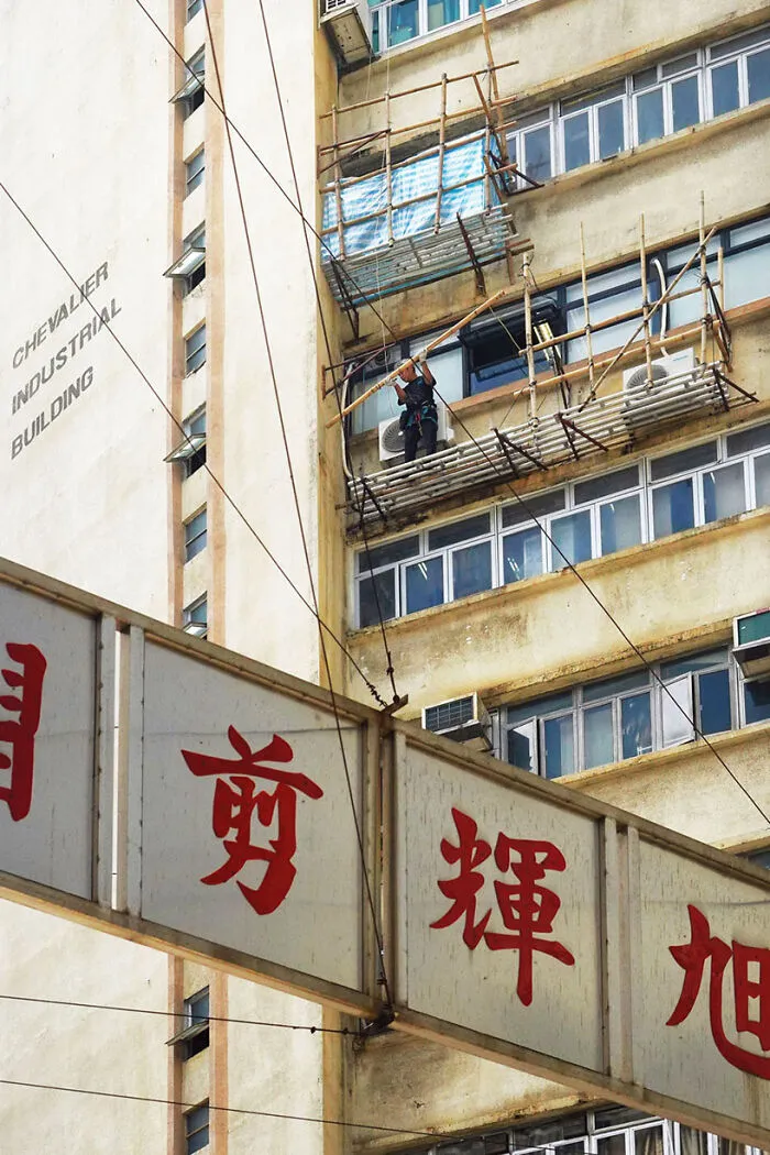 Repair Chevalier, 2024 - A Worker Holding A Bamboo Pole For The Scaffolding He Is Constructing
