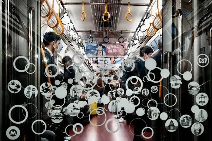 Passengers in a subway car with lucky coincidences; circles on the window align with interior elements, creating a unique effect.