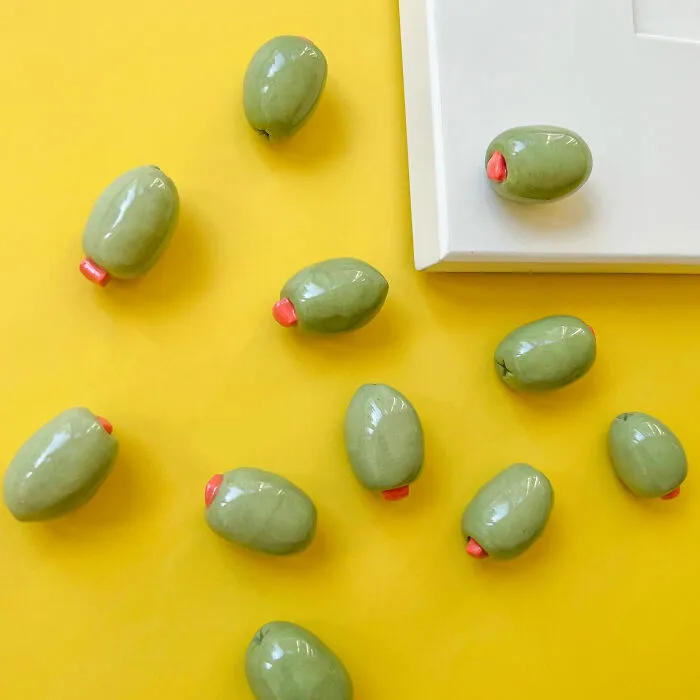 Opening Doors Just Got A Whole Lot More Martini-Adjacent Thanks To These Unique <a Style="Display:inline;" Href="Https://Www.etsy.com/Listing/1878577245/Handmade-Stuffed-Jumbo-Olive-Knobs?ls=s&ga_order=most_relevant&ga_search_type=all&ga_view_type=gallery&ga_search_query=stuffed+olive+doorknob&ref=sr_gallery-1-1&etp=1&sts=1&content_source=aa49414ea9a5006cc2524315b134e45074ee5565%253a1878577245&search_preloaded_img=1&organic_search_click=1&logging_key=aa49414ea9a5006cc2524315b134e45074ee5565%3a1878577245" Target="_blank"><span Style="Font: Inherit; Color: #d74b1f;"> Stuffed Olive Doorknobs </Span>