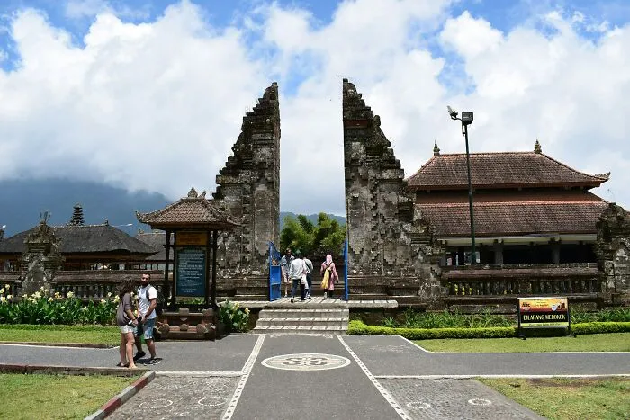 Tourists at a historic site, one of the disappointing FOMO experiences shared in travel stories.