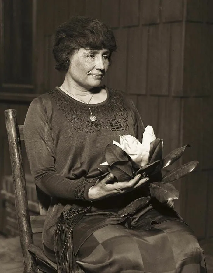 Elderly woman holding flowers, representing inspiring forbidden stories with global significance.