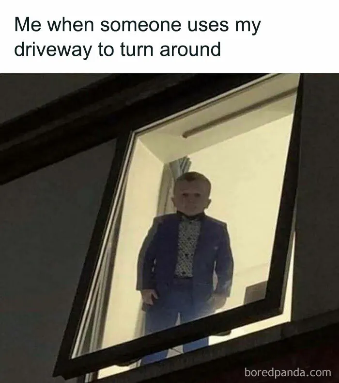Man looking sternly out a window, illustrating a humorous meme about using a driveway.