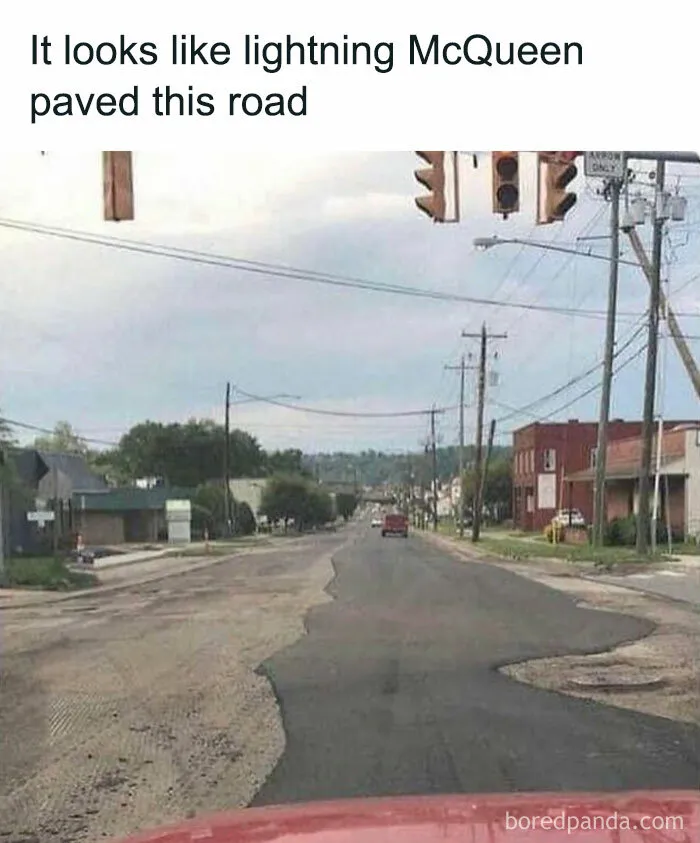Bumpy road resembling Lightning McQueen's haphazard paving, with traffic light and street view, humor about men.