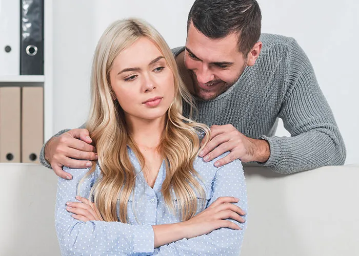 Couple having a tense moment, woman looking away in thought, highlighting relationship changes from phone discoveries.