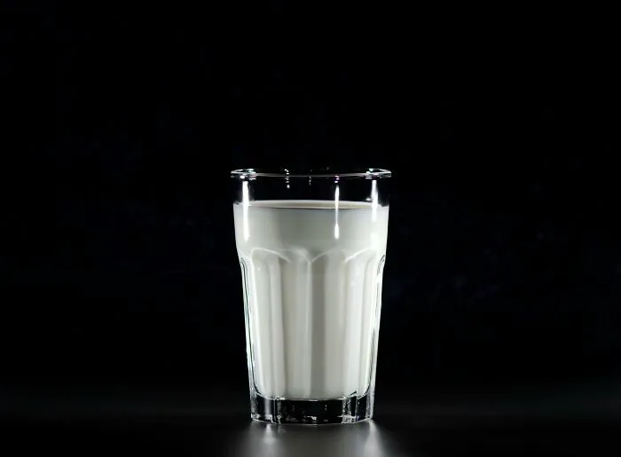 Glass of milk on a dark background, illustrating unpopular opinions.