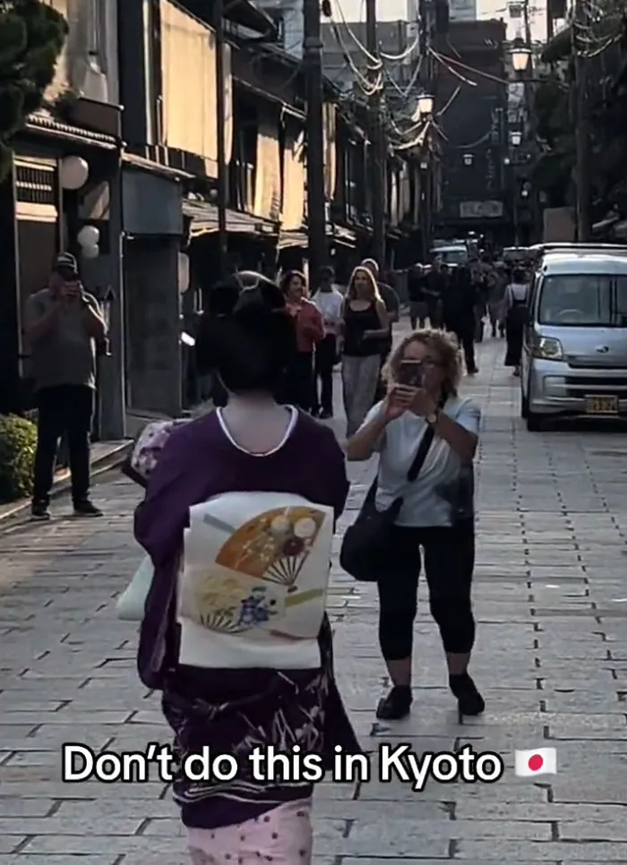 Tourist Chasing Geisha To Take Photos Of Her